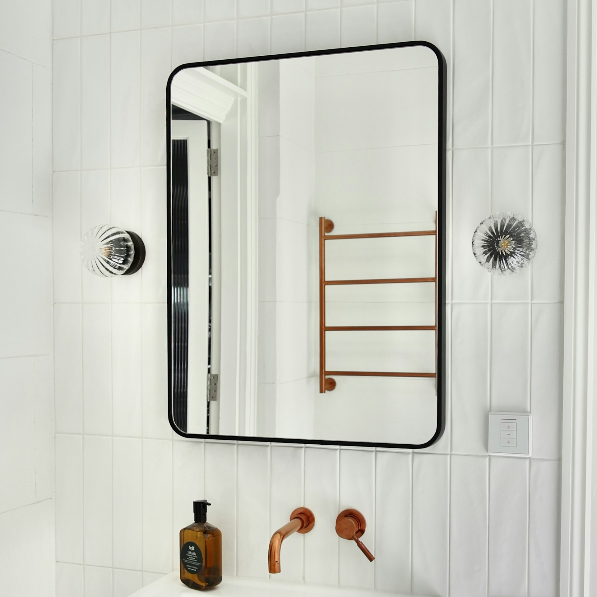 Elegant illuminated bathroom mirror and furniture