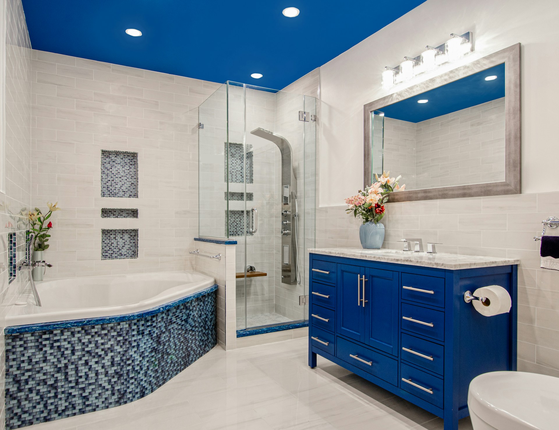 Intricate glass and stone mosaic tiles in a luxury pool and spa setting