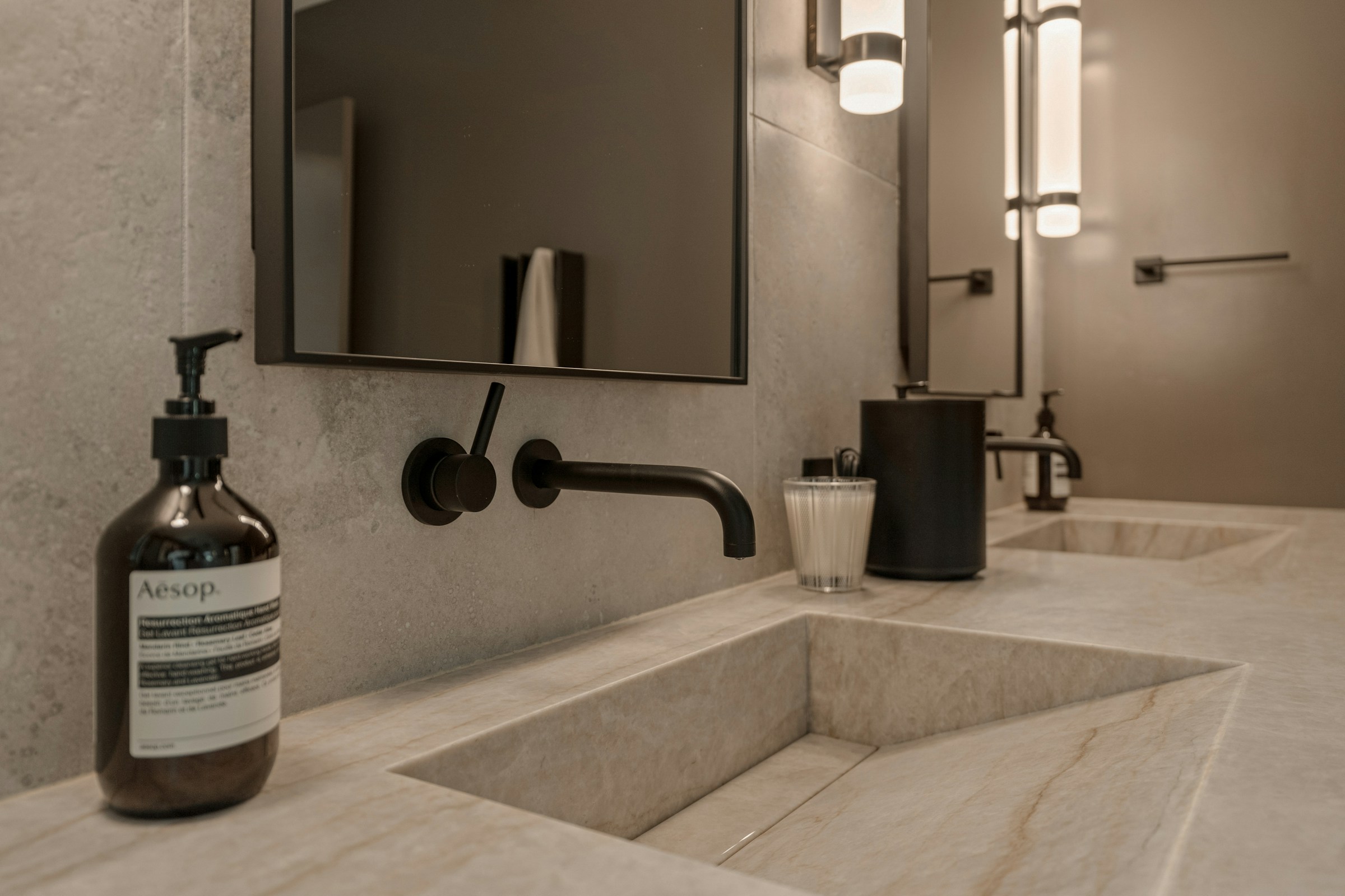 Luxurious tiled bathroom showcasing premium tile installation with gold fixtures