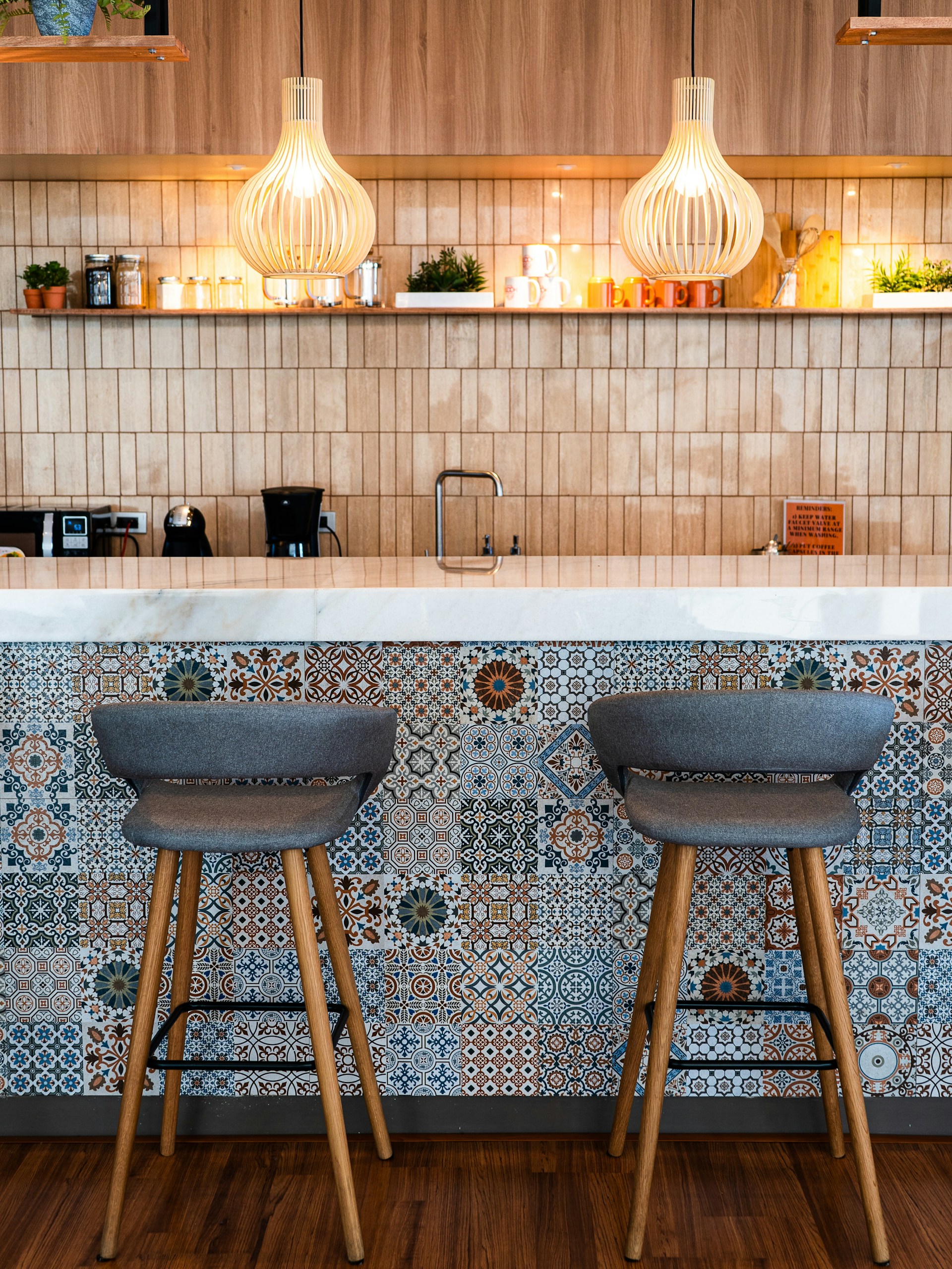 Designer tiles creating a stunning kitchen floor and splashback in a modern home