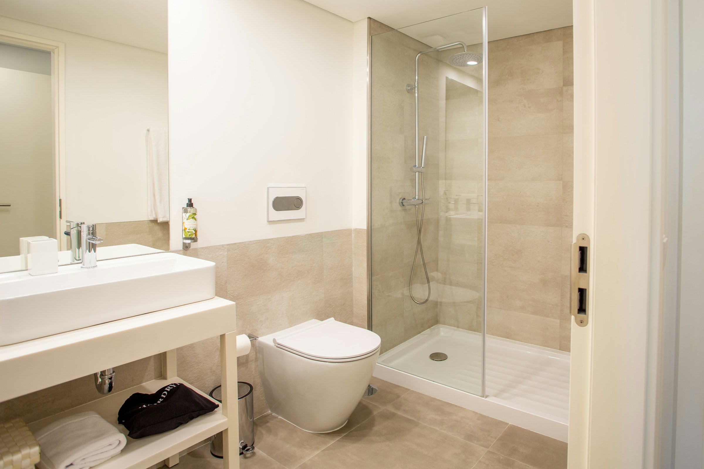 Walk-in shower enclosure with premium rainfall head and stone tiles